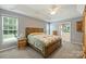 Spacious main bedroom with a tray ceiling, carpet, and an en-suite bathroom with a soaking tub at 1117 Yarrow St, Matthews, NC 28104