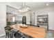 Open-concept dining and living space, featuring a large wooden table and bar cabinet at 1121 Freeman View Dr, Albemarle, NC 28001