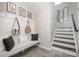 Welcoming entryway featuring a built-in bench, storage hooks, and a staircase at 1121 Freeman View Dr, Albemarle, NC 28001