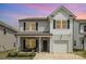 Charming two-story home with a covered front porch, stone accents, and a two-car garage at 1121 Freeman View Dr, Albemarle, NC 28001