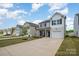 View of several homes on the street featuring a driveway and well manicured front lawns at 1121 Freeman View Dr, Albemarle, NC 28001