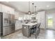 Beautiful kitchen boasts white cabinets, a center island with barstool seating, and stainless steel appliances at 1121 Freeman View Dr, Albemarle, NC 28001