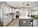 Bright kitchen features white cabinetry, a center island with seating, and stainless steel appliances at 1121 Freeman View Dr, Albemarle, NC 28001