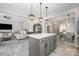 View of kitchen island with seating, open floor plan concept connecting living, dining and kitchen at 1121 Freeman View Dr, Albemarle, NC 28001