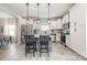 Open kitchen featuring an island with bar seating and pendant lights, stainless appliances, and wood-look flooring at 1121 Freeman View Dr, Albemarle, NC 28001