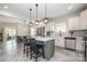 Bright kitchen with stainless steel appliances, island with seating, and open access to the dining and living areas at 1121 Freeman View Dr, Albemarle, NC 28001