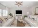 Bright living room features a large window, neutral sofas, and modern furnishings and decor at 1121 Freeman View Dr, Albemarle, NC 28001