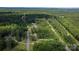 An aerial view of the property on a wooded lot, showing location near a train track at 1154 Stringfellow Rd, Chester, SC 29706