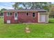 Rear view of brick home with covered entrance and spacious, green yard at 1154 Stringfellow Rd, Chester, SC 29706