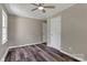 Bedroom featuring neutral walls, wood-look flooring, a ceiling fan, and closet doors at 1154 Stringfellow Rd, Chester, SC 29706