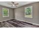 Bedroom featuring neutral walls, wood-look flooring, a ceiling fan, and two windows with a view at 1154 Stringfellow Rd, Chester, SC 29706