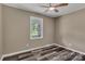 Bedroom featuring neutral walls, wood-look flooring, a ceiling fan, and a window with a view at 1154 Stringfellow Rd, Chester, SC 29706