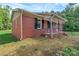 Brick home with black shutters and covered porch, surrounded by green grass at 1154 Stringfellow Rd, Chester, SC 29706
