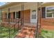 Charming brick home featuring a covered porch with decorative wrought iron railings at 1154 Stringfellow Rd, Chester, SC 29706