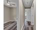Hallway with wood-look flooring leading to a bedroom, showcasing neutral walls and a ceiling fan at 1154 Stringfellow Rd, Chester, SC 29706