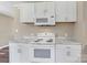 Kitchen features stove, microwave, and marble-look countertops at 1154 Stringfellow Rd, Chester, SC 29706