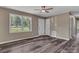 Open front door to the living room with wood-look floors and view of the covered porch at 1154 Stringfellow Rd, Chester, SC 29706