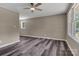 Bright living room with wood-look flooring, neutral walls, and a ceiling fan at 1154 Stringfellow Rd, Chester, SC 29706