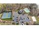 Aerial view of tennis courts, community pool, parking and lake access at 129 Willow Tree Ln, Mount Holly, NC 28120