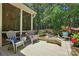 Outdoor patio with a view, adorned with comfortable seating and colorful flower arrangements at 129 Willow Tree Ln, Mount Holly, NC 28120