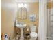 Bathroom with a pedestal sink, commode and shower-tub combo with neutral wall color at 129 Willow Tree Ln, Mount Holly, NC 28120