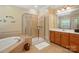 Bathroom showcasing a glass shower enclosure, soaking tub, and double sink vanity with granite countertop at 129 Willow Tree Ln, Mount Holly, NC 28120