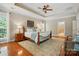 Bedroom featuring a ceiling fan, plush rug, and an ensuite bathroom for added convenience at 129 Willow Tree Ln, Mount Holly, NC 28120