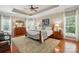 Comfortable bedroom with a tray ceiling, ceiling fan, and wooden furniture accents at 129 Willow Tree Ln, Mount Holly, NC 28120