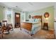 Bright bedroom with natural light, and vintage-style wooden furniture including a wood bed frame at 129 Willow Tree Ln, Mount Holly, NC 28120