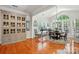 Dining room with wood floors, large windows, decorative chandelier, and built-in cabinet at 129 Willow Tree Ln, Mount Holly, NC 28120
