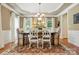 Elegant dining room with decorative rug, chandelier, and neutral color scheme at 129 Willow Tree Ln, Mount Holly, NC 28120