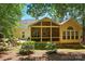 Exterior of home featuring back patio, screened-in porch and deck perfect for outdoor entertaining at 129 Willow Tree Ln, Mount Holly, NC 28120