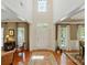 Grand two-story foyer featuring hardwood floors, transom windows, and elegant architectural details at 129 Willow Tree Ln, Mount Holly, NC 28120