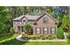 Charming brick two-story home featuring manicured landscaping and a welcoming front porch at 129 Willow Tree Ln, Mount Holly, NC 28120
