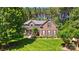 Beautiful brick home featuring a well-maintained lawn and professionally landscaped front yard at 129 Willow Tree Ln, Mount Holly, NC 28120