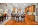 Open kitchen with wooden cabinets, a breakfast bar, and hardwood floors at 129 Willow Tree Ln, Mount Holly, NC 28120