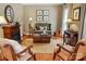 Cozy living room with a fireplace, seating, decorative accents, and wood floors at 129 Willow Tree Ln, Mount Holly, NC 28120