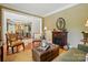 Comfortable living room with a fireplace, seating, decorative accents, and wood floors at 129 Willow Tree Ln, Mount Holly, NC 28120