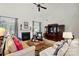 Spacious living room with a cozy fireplace, large windows, and comfortable seating arrangement at 129 Willow Tree Ln, Mount Holly, NC 28120
