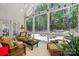 Charming screened porch with plenty of natural light and comfortable furniture, surrounded by beautiful greenery at 129 Willow Tree Ln, Mount Holly, NC 28120