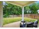 Private backyard featuring a covered patio, a well-maintained lawn, and a wooden fence for privacy at 14402 Asheton Creek Dr, Charlotte, NC 28273