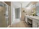 Well-lit bathroom with white vanity and tiled floor, plus shower and enclosed toilet at 14402 Asheton Creek Dr, Charlotte, NC 28273