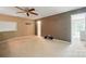 Spacious bedroom with neutral walls and a ceiling fan, ready for personalization and relaxation at 14402 Asheton Creek Dr, Charlotte, NC 28273