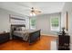 Cozy bedroom featuring a sled bed frame, ceiling fan, and hardwood floors at 14402 Asheton Creek Dr, Charlotte, NC 28273