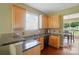Updated kitchen with granite countertops, wood cabinets, and a stainless-steel dishwasher at 14402 Asheton Creek Dr, Charlotte, NC 28273