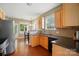 Bright kitchen featuring granite countertops, wood cabinets, and modern appliances at 14402 Asheton Creek Dr, Charlotte, NC 28273
