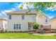 Spacious backyard featuring a patio, deck, green grass, and mature landscaping at 14426 Harvington Dr, Huntersville, NC 28078