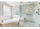 This bathroom features a soaking tub and separate glass shower at 14426 Harvington Dr, Huntersville, NC 28078