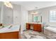 This bathroom has dual sinks, vanity and soaking tub at 14426 Harvington Dr, Huntersville, NC 28078