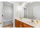 Updated bathroom features double sinks, white cabinets, new fixtures and tile floors at 14426 Harvington Dr, Huntersville, NC 28078